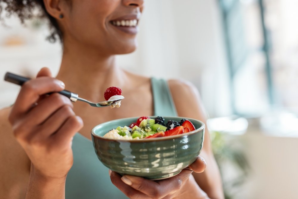 girl eating healthy food (likely fruits)