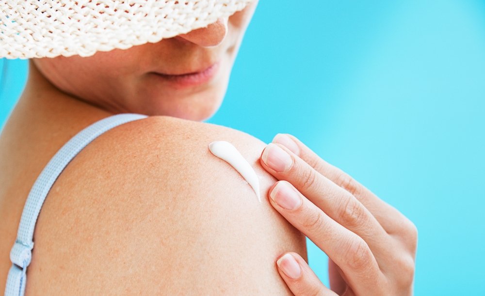 women applying skin protection cream